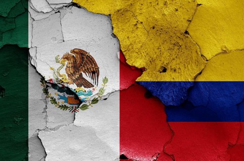 Flags of Mexico and Colombia painted on cracked wall