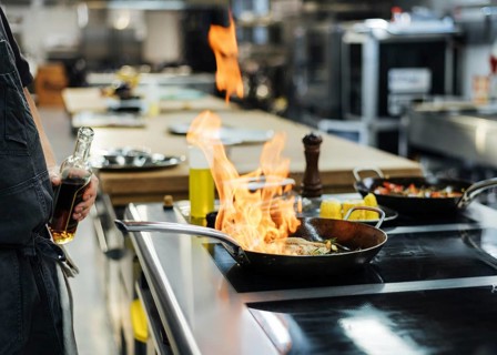Side view chef flambeing dish kitchen. Resolution and high quality beautiful photo