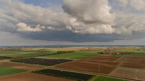Landscape with wide fields and dramatic clouds in the sky, Straubing, Lower Bavaria, Germany