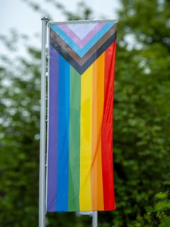 A rainbow flag hangs in front of the building of the Protestant Church of the Palatinate on
