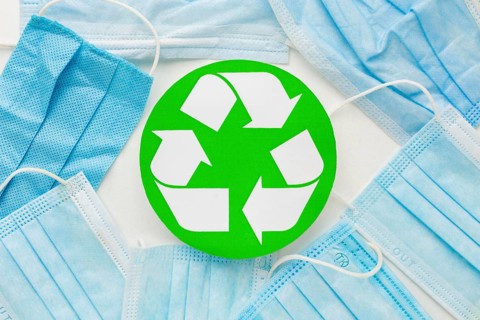 Top view disposable medical masks recycle symbol