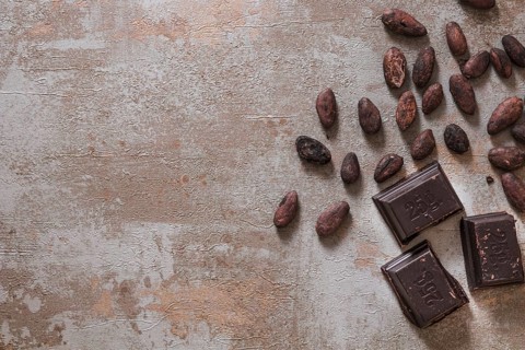 Chocolate pieces with raw cocoa beans rustic background. Resolution and high quality beautiful