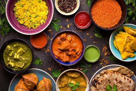 Assorted indian food on dark wooden background. Dishes and appetizers of indian cuisine. Curry,