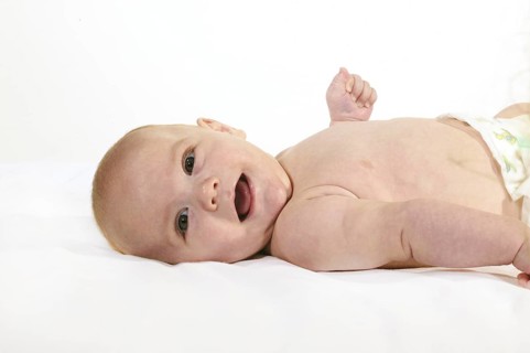 SMILING BOY AGAINST WHITE BACKGROUND