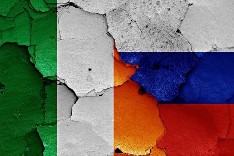 Flags of Ireland and Russia painted on cracked wall