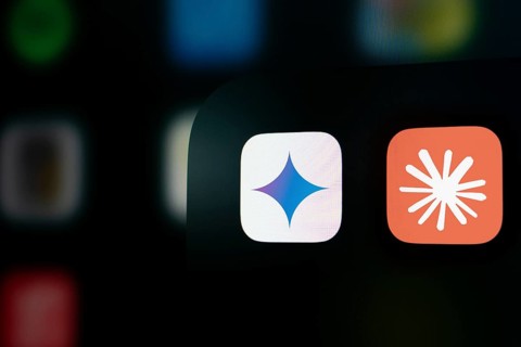 A close up of an iPhone screen displaying the Google Gemini and Claude AI app icon.