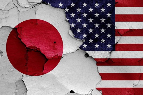 Flags of Japan and USA painted on cracked wall