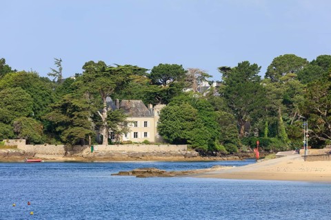 Coast of Combrit, district Le Moguer with historic villa by the sea, seen from Benodet, department
