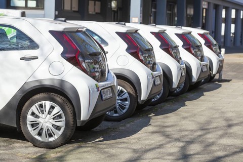 White small cars parked in a row, rear view, Germany