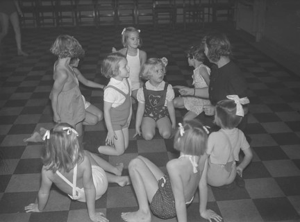 Children in the 1930s. A group of small girls at a dancing school playing together. Photo