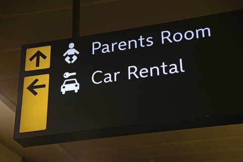 Airport signage for the parents room and car rental at Wellington, New Zealand