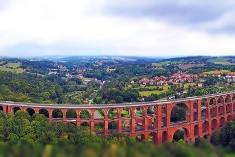 Aerial view of the Göltzsch Valley Bridge, an impressive brick viaduct that spans majestically over