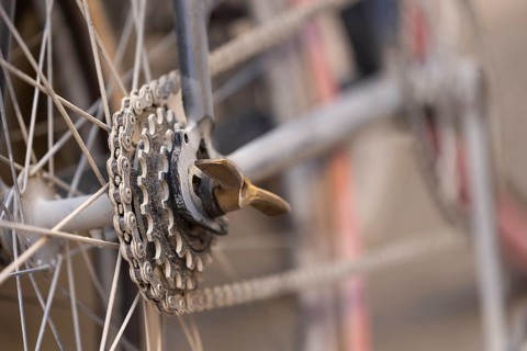 Close-up of a dusty bicycle sprocket and blurred background, at the legendary cycling race