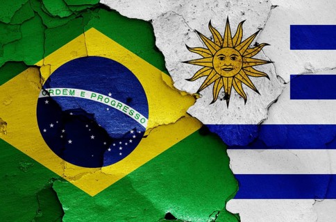Flags of Brazil and Uruguay painted on cracked wall