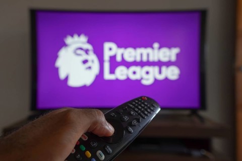May 14, 2024, Brazil. In this photo illustration, a hand holding a TV remote control in front of