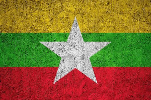 Myanmar flag painted on the cracked grunge concrete wall