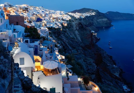 Blue hour after sunset, view from Oia to white buildings on the crater rim, Santorini, Cyclades,
