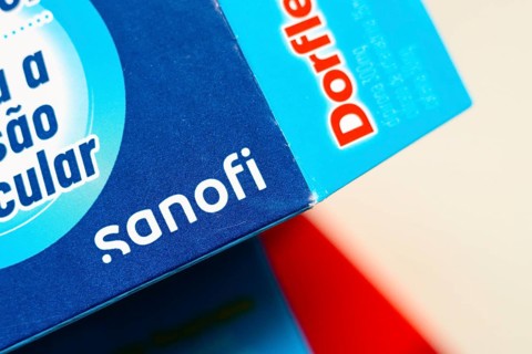In this photo illustration, the Sanofi logo is seen on the box of the medicine Dorflex, used as an