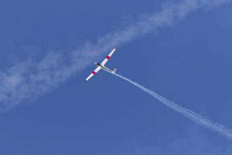 Airshow, glider with contrails against blue sky, Montreal, Province of Quebec, Canada