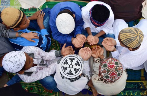 Young Muslim boys offer prayer as they celebrate Eid al-Adha or festival of sacrifice, at the Bilal