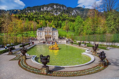 Water parterre with flora fountain and the portal of Linderhof Castle in spring, municipality of