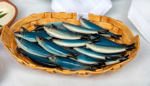 Bowl of pottery ceramic fish sardines in gift shop, city of Guimaraes, northern Portugal