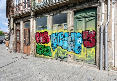 Street graffiti tagged spray painted on building frontages, city of Guimaraes, Portugal