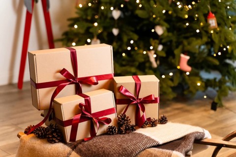 Groups of Christmas presents with craft papers on the sledges against the backdrop of a Christmas