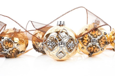 Luxurious antique golden christmas balls decorated with brown ribbon. Traditional festive xmas