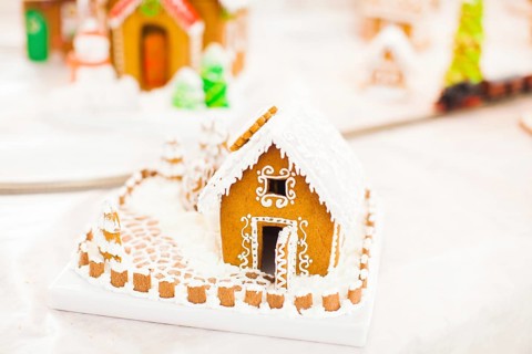 Gingerbread cookie house in the Christmas village on the fair. Holiday traditional aroma dessert