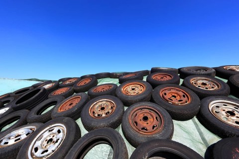 Old wheels, rims and tyres, used here to weigh down the cover of an agricultural silo
