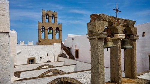 Historic architecture with bell tower under a blue sky, St John's Monastery, Ancient columned