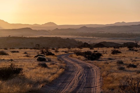 Sandy track, desert landscape in the evening light at sunset, backlit, Brandberg, Erongo,