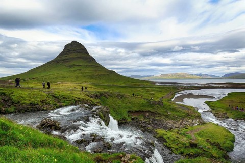 Kirkjufell mountain, film set, hikers, tourists at Kirkjufellfoss waterfall, Kirkjufellsa river,