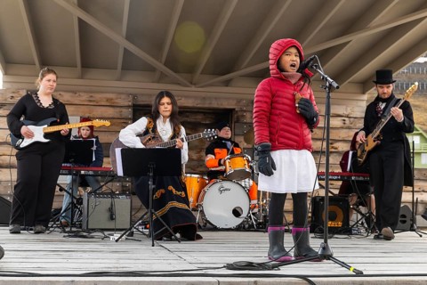 Girl sings with band at the reception for King Harald at the end of coal mining, Longyearbyen,