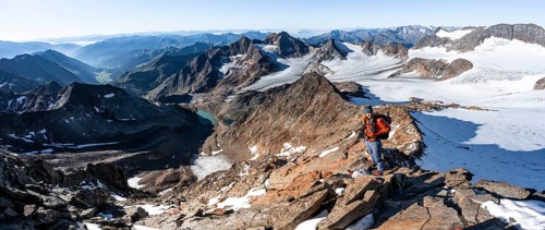 Mountaineer on a rocky ridge on the Wilder Freiger summit, behind him Signal summit and Becher