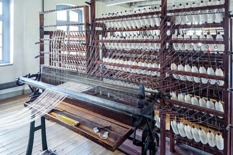 Bramsche, Lower Saxony, Germany, weaving machine, loom, in a textile factory, numerous spools of