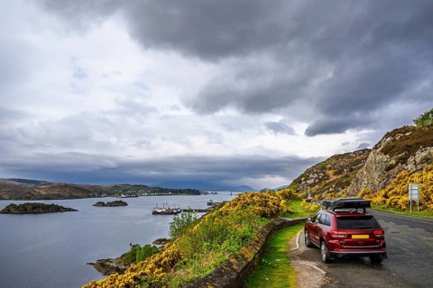 Off road 4x4 car with roof tent over Skye Bridge over Loch Alsh, Kyle of Lochalsh, Isle of Skye,