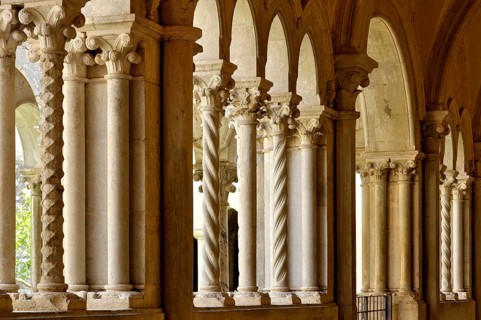 Slender Gothic columns, double columns with filigree capitals in the cloister, Gothic basilica of