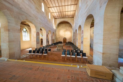 Church interior with pews and cross under bright daylight, event and wedding location Lorch