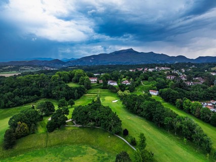Sunset and storm clouds over Pyrenees and Saint-Jean-de-Luz from a drone, Nouvelle-Aquitaine,