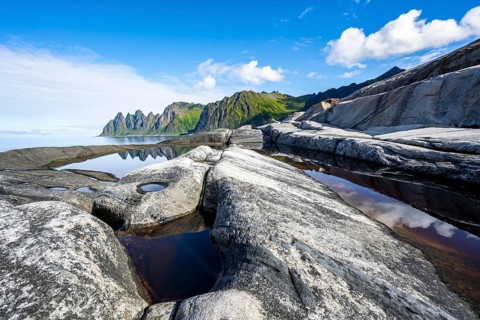 Reflection in a tidal pool, rocky coast of Tungeneset, Devil's Teeth, Okshornan, Ersfjorden, Senja