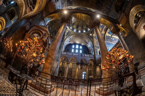Wide angle view of the illuminated interior of saint mark's basilica in venice, italy, showcasing