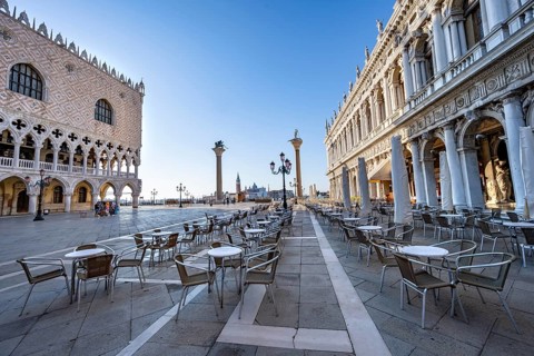 Chairs and tables of cafes at Piazetta San Marco, Doge's Palace and Colonna di San Marco and