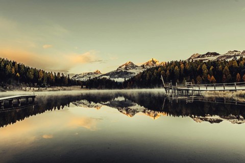 Lake Staz near Sankt Moritz in the Engadin in Switzerland. Morning atmosphere with fog in autumn.