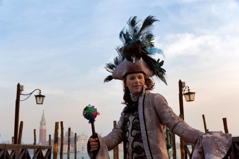 Tourist at the carnival, Venetian costume with hat, disguised man, boat dock at St Mark's Square,
