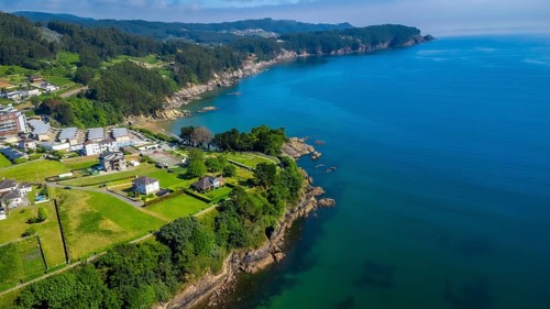 Breathtaking aerial view of covas beach meeting the cantabrian sea, showcasing the stunning