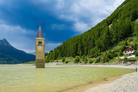 Bell tower of the former parish church of St Catherine in the sunken village of Alt-Graun in Lake