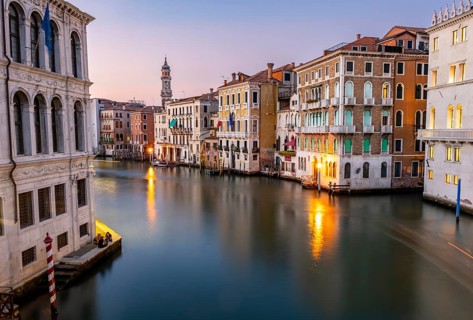 View of the Grand Canal at sunset, picturesque evening mood with illuminated palazzos on the canal