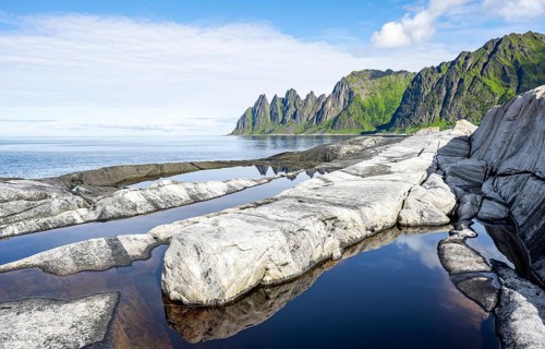 Reflection in a tidal pool, rocky coast of Tungeneset, Devil's Teeth, Okshornan, Ersfjorden, Senja
